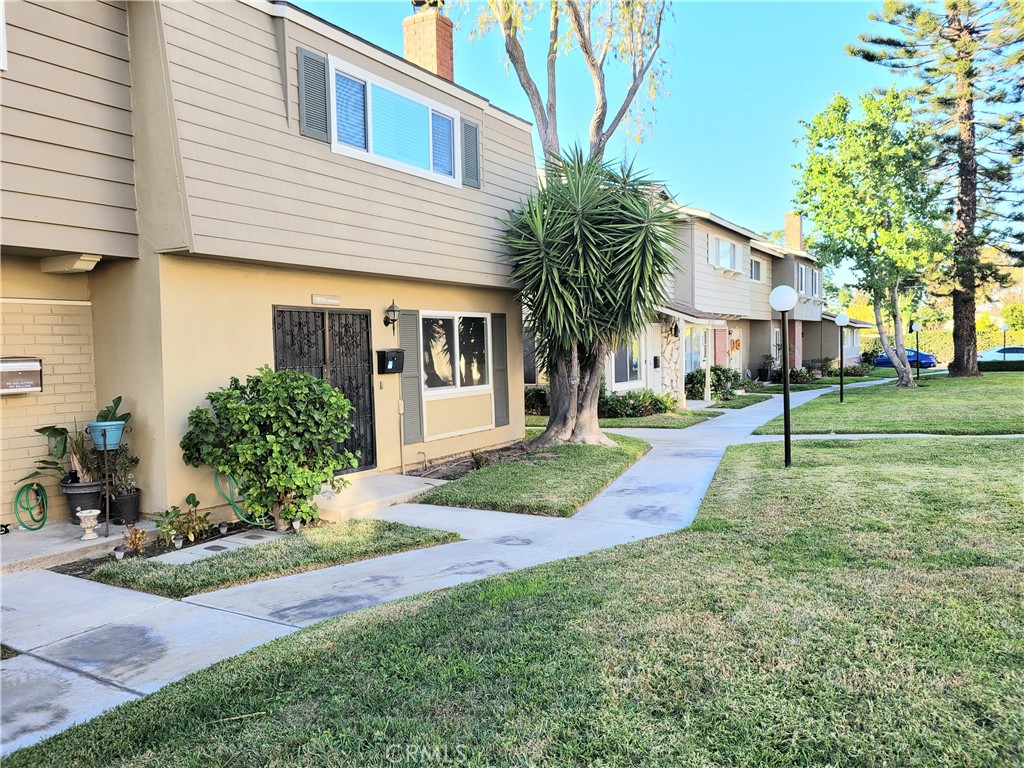 11896 Firebrand Circle Garden Grove, CA 92840 - Photo 31 of 37 a view of a white house with a yard and potted plants