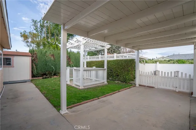 a view of a chair and table in backyard of the house