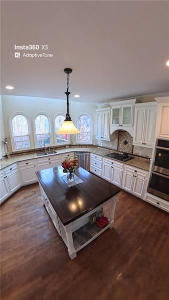12313 Sunset Maple Terrace Alpharetta, GA 30005 - Photo 9 of 31 a kitchen with granite countertop a stove and cabinets