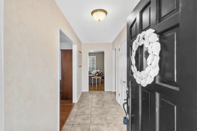 a living room with furniture fireplace and wooden floor