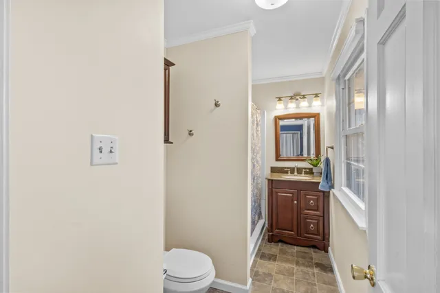 a bedroom with a bed and chandelier