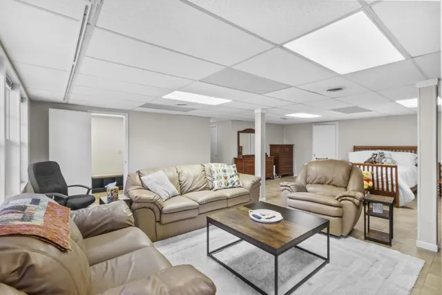 a view of a dry yard with trees in the background