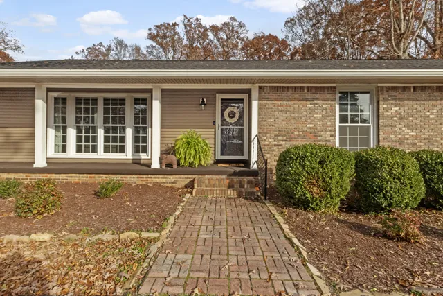 a view of balcony with wooden floor and outdoor seating