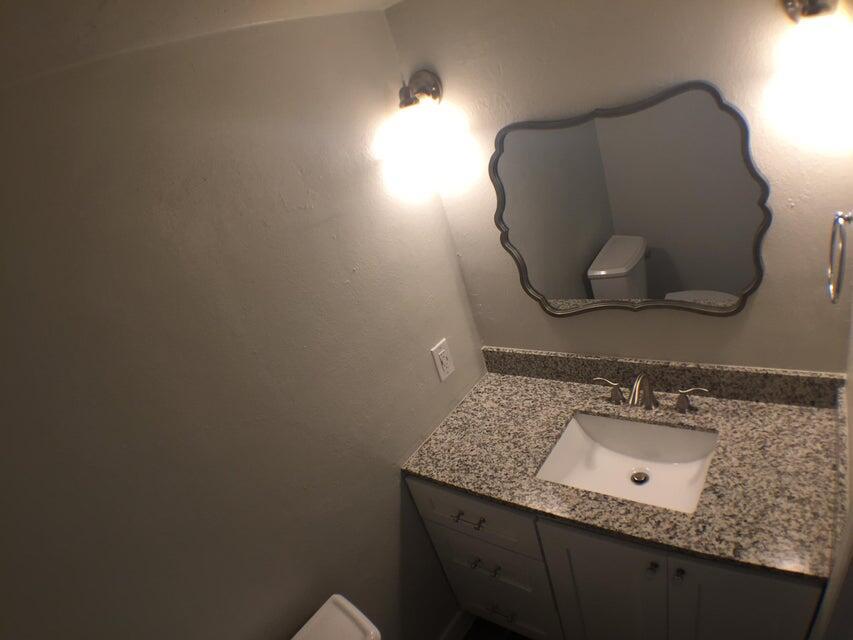 660 Glouchester Street, Unit 105 Boca Raton, FL 33487 - Photo 7 of 13 a bathroom with a sink vanity and mirror