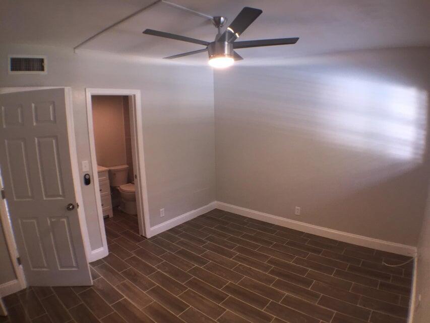 660 Glouchester Street, Unit 105 Boca Raton, FL 33487 - Photo 9 of 13 wooden floor in an empty room