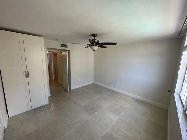 an empty room with a ceiling fan