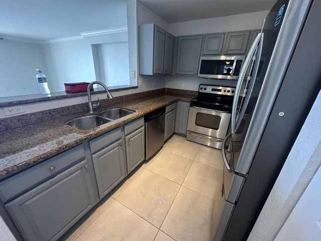 a kitchen with a sink stove and cabinets