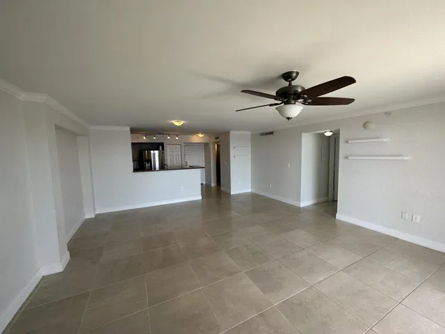 a view of a kitchen with a sink and a ceiling fan