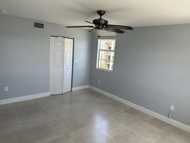 a view of an empty room and a window