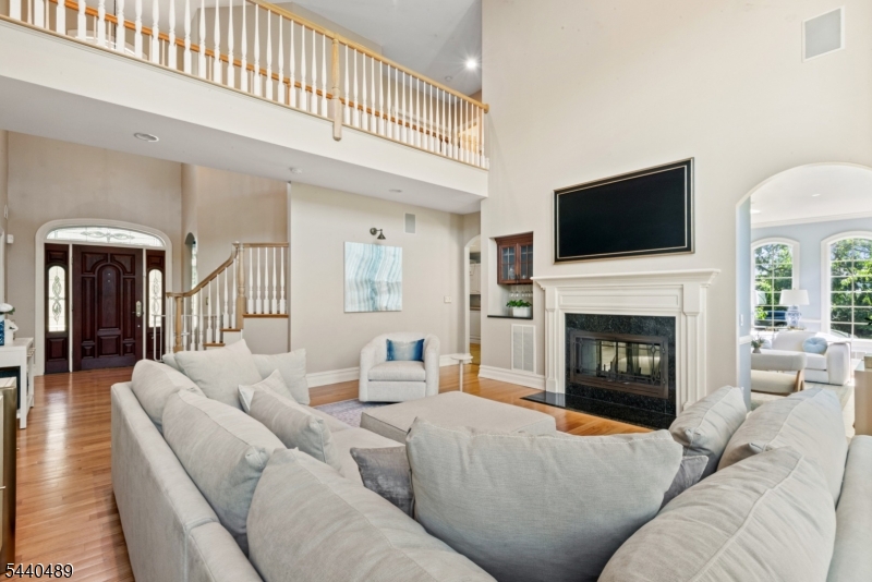 99 East Lindsley Road Cedar Grove, NJ 07009 - Photo 6 of 41 a living room with furniture a fireplace and a flat screen tv