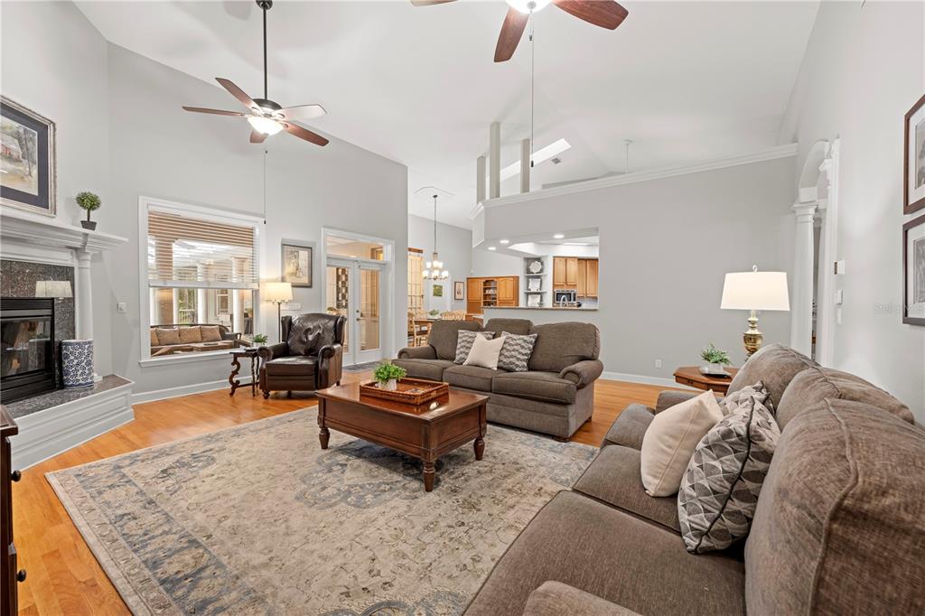 23245 Croom Road Brooksville, FL 34601 - Photo 13 of 79 a living room with furniture a fireplace and a chandelier