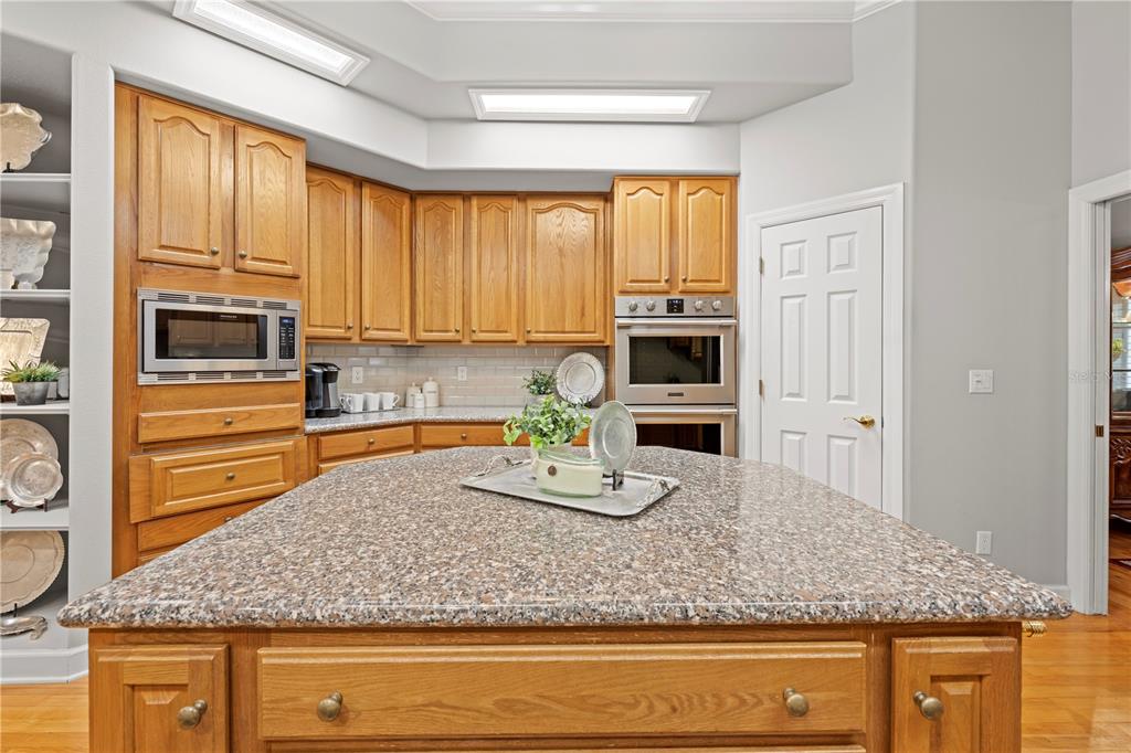 23245 Croom Road Brooksville, FL 34601 - Photo 17 of 79 a kitchen with stainless steel appliances granite countertop a stove a sink and a microwave