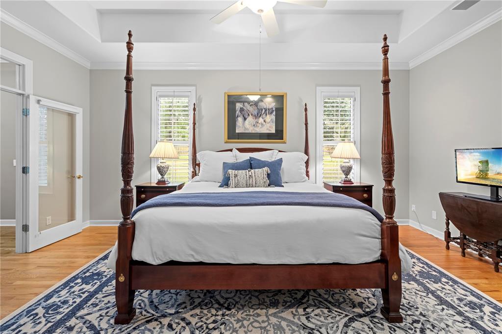 23245 Croom Road Brooksville, FL 34601 - Photo 29 of 79 a bedroom with a bed a dresser and wooden floor