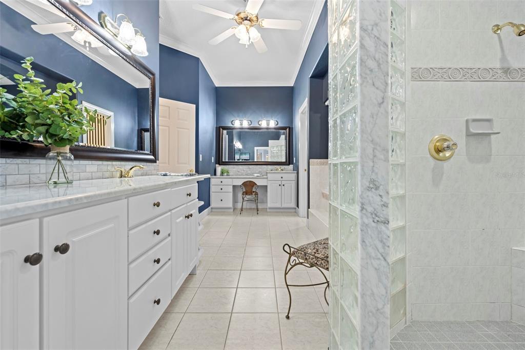 23245 Croom Road Brooksville, FL 34601 - Photo 35 of 79 a spacious bathroom with a double vanity sink a mirror and a shower