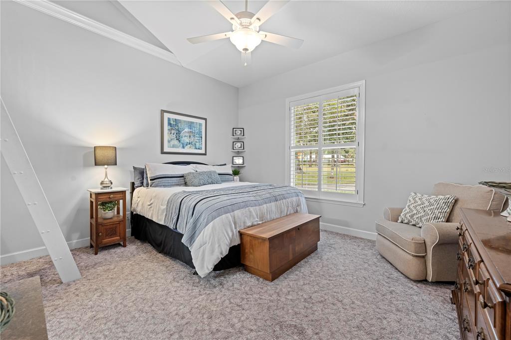 23245 Croom Road Brooksville, FL 34601 - Photo 42 of 79 a spacious bedroom with a bed and a couch