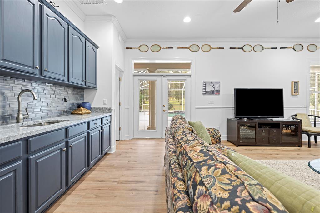 23245 Croom Road Brooksville, FL 34601 - Photo 51 of 79 a large kitchen with cabinets a sink and a wooden floor