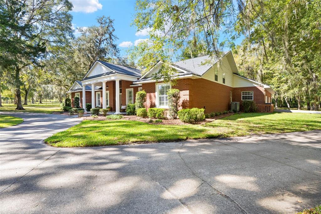 23245 Croom Road Brooksville, FL 34601 - Photo 69 of 79 a front view of house with yard and green space