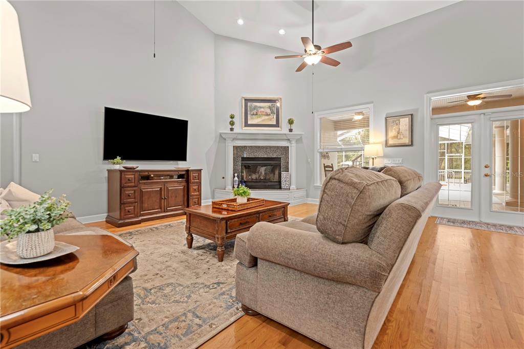 23245 Croom Road Brooksville, FL 34601 - Photo 9 of 79 a living room with furniture a fireplace and a flat screen tv