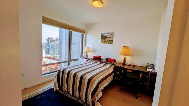 a bed sitting in a bedroom next to a window