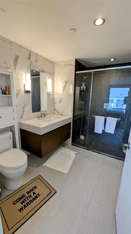 a bathroom with a double vanity sink mirror and toilet