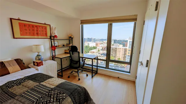 a bedroom with furniture and a large window