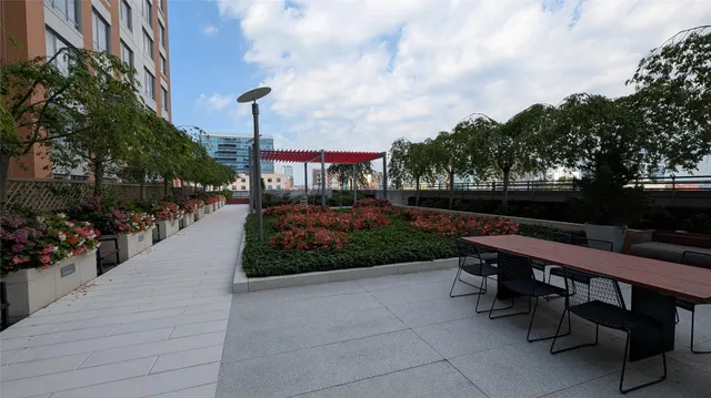 a view of a patio with chairs and a small yard