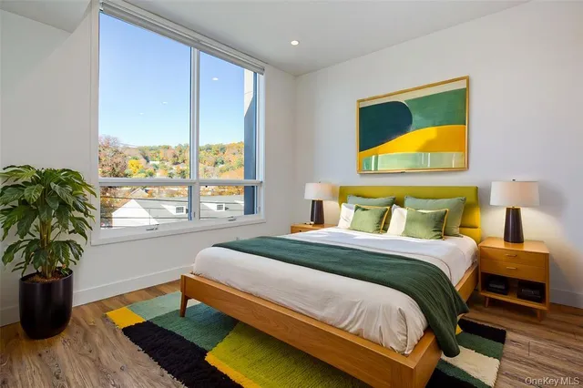 a bedroom with a bed and a potted plant