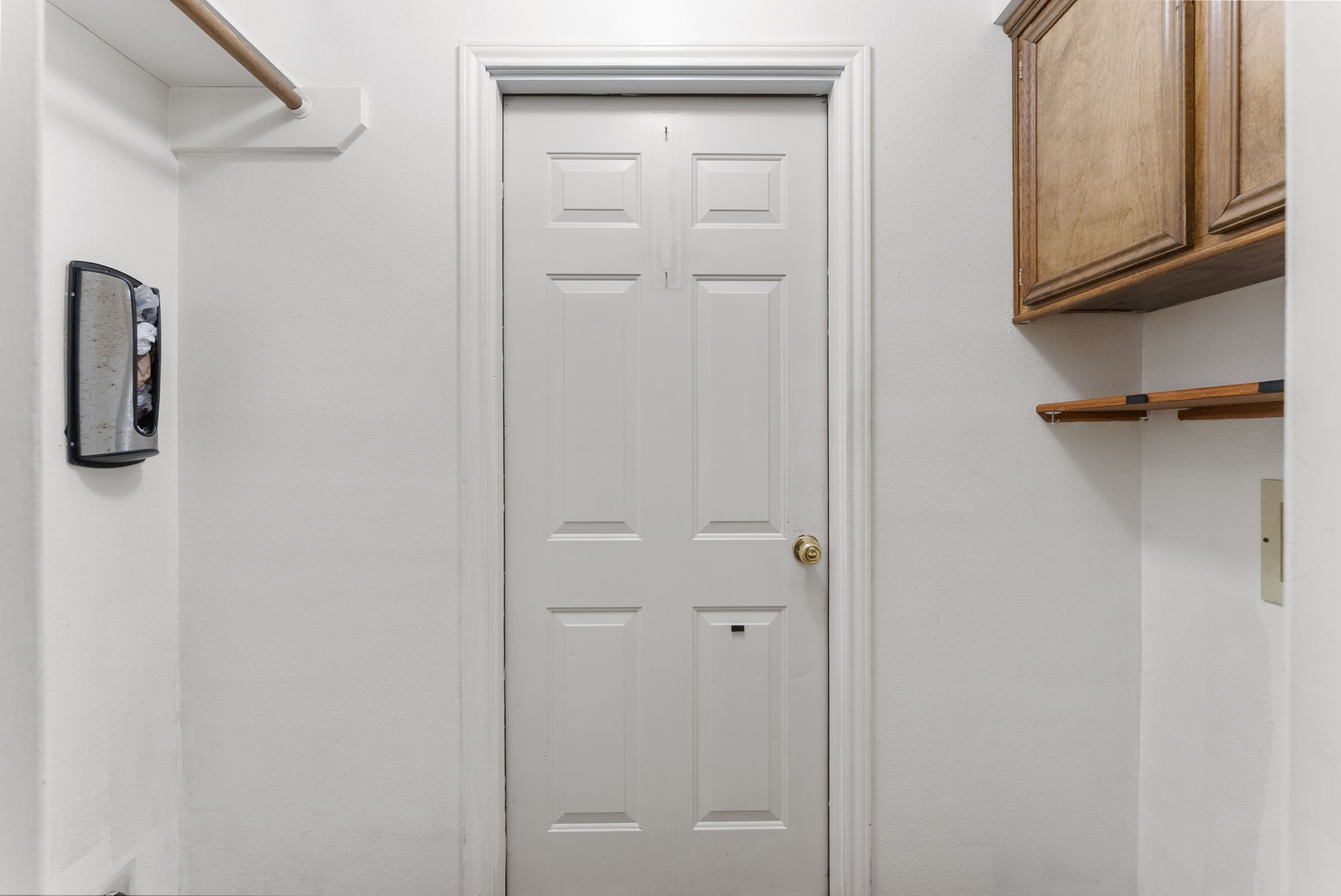 202 Sunset Boulevard Conroe, TX 77303 - Photo 20 of 50 This laundry room offers efficient storage with sleek cabinetry and a practical hanging rod, all in a bright, functional space.