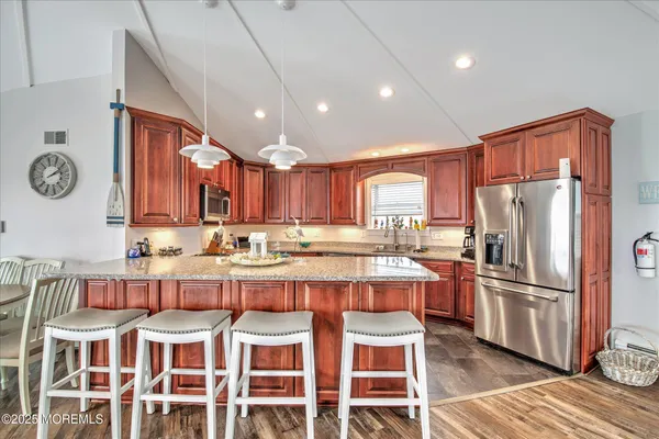 a kitchen with a refrigerator and microwave