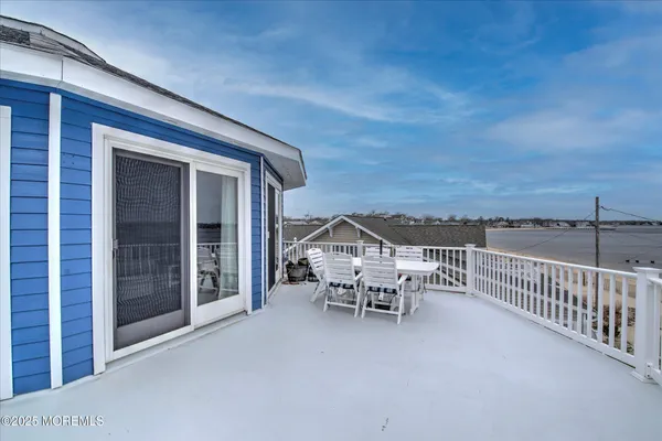 a roof deck with a table and chairs