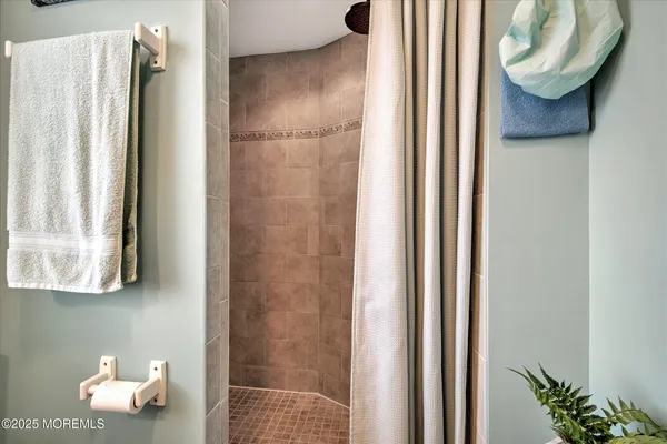 a bathroom with a toilet and a mirror