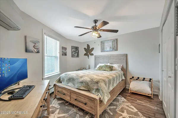 a bedroom with a bed chandelier and a window