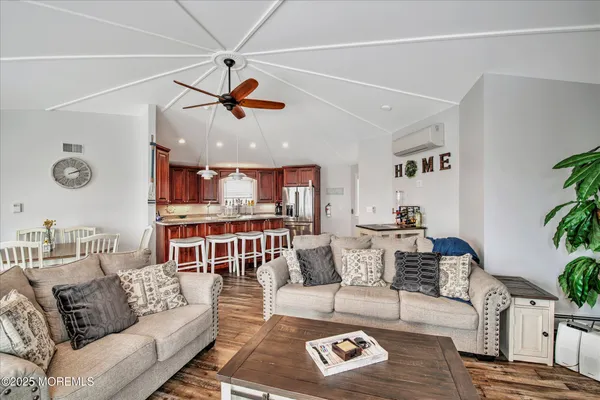 a living room with furniture a ceiling fan and a rug