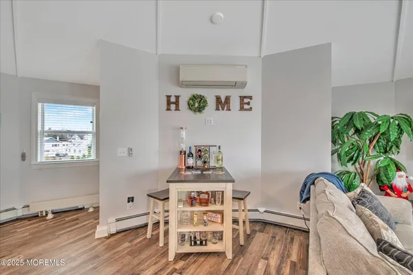 a view of a workspace with furniture and wooden floor