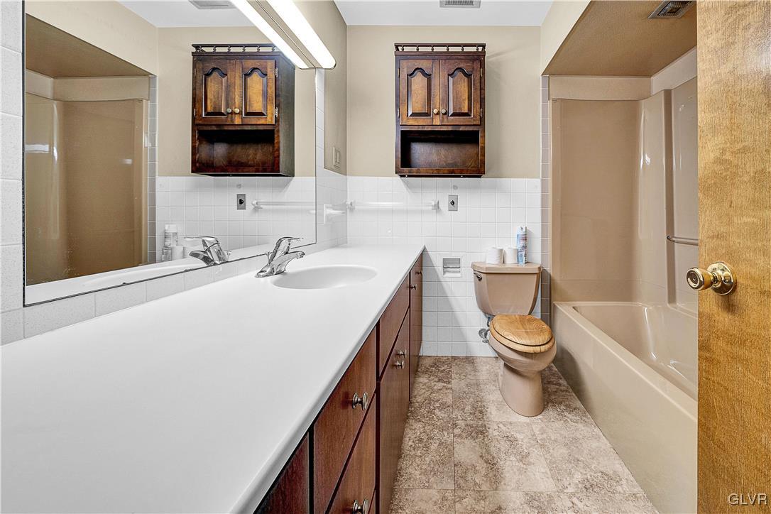 5651 Park Valley Road Schnecksville, PA 18078 - Photo 15 of 32 a bathroom with a toilet sink and mirror