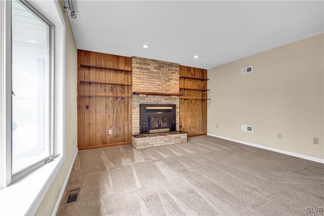 5651 Park Valley Road Schnecksville, PA 18078 - Photo 2 of 32 a view of an empty room with a fireplace and a window