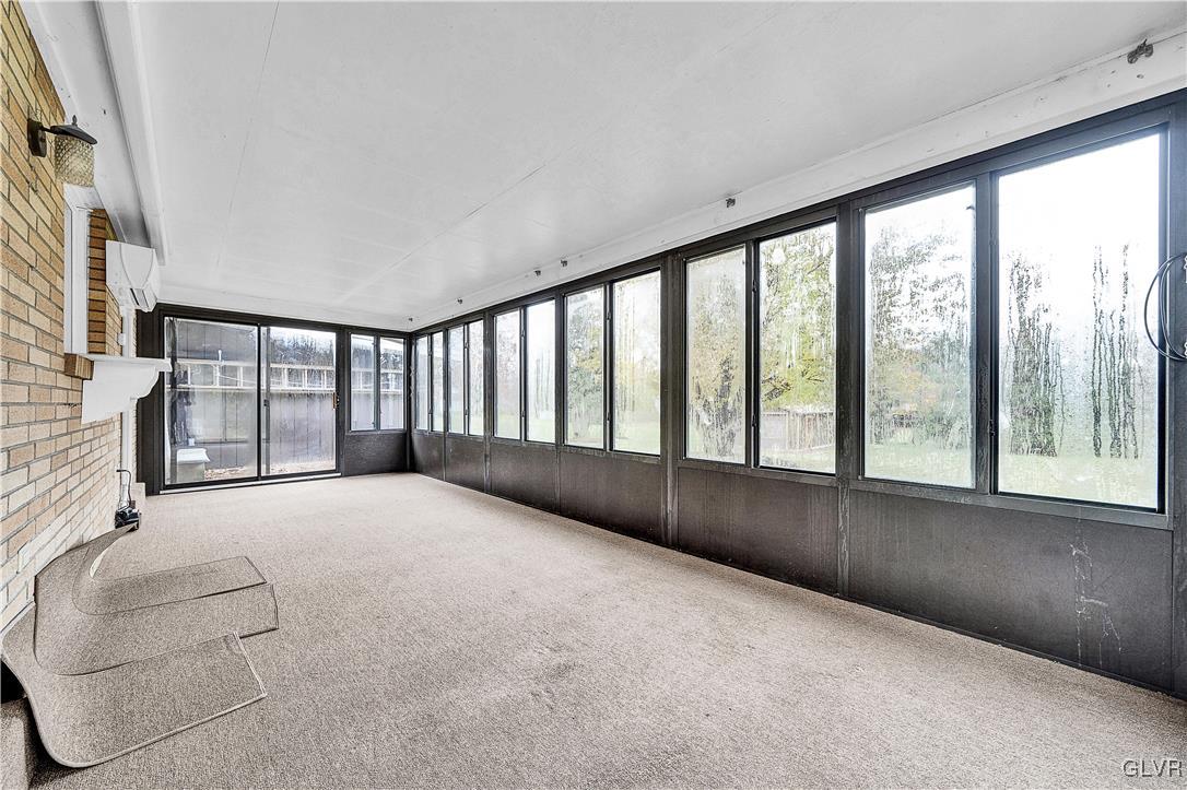 5651 Park Valley Road Schnecksville, PA 18078 - Photo 23 of 32 a living room with a large bed and a large window