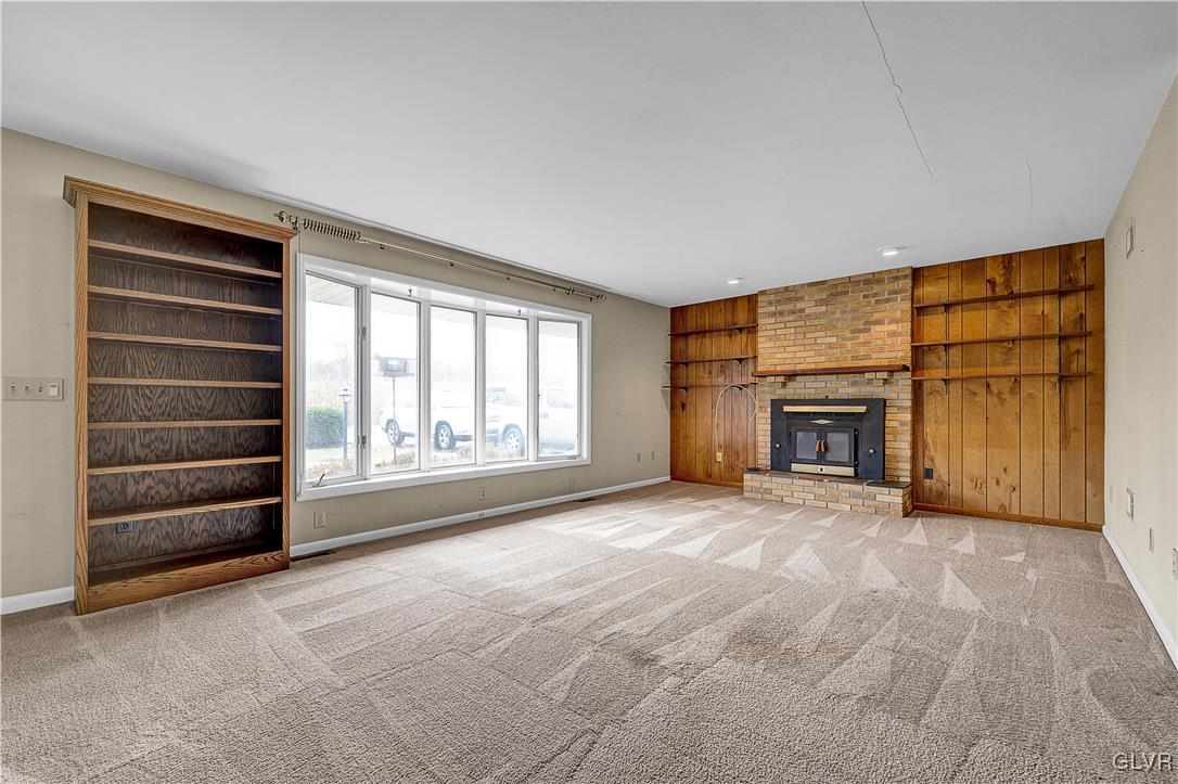 5651 Park Valley Road Schnecksville, PA 18078 - Photo 4 of 32 an empty room with furniture and a fireplace