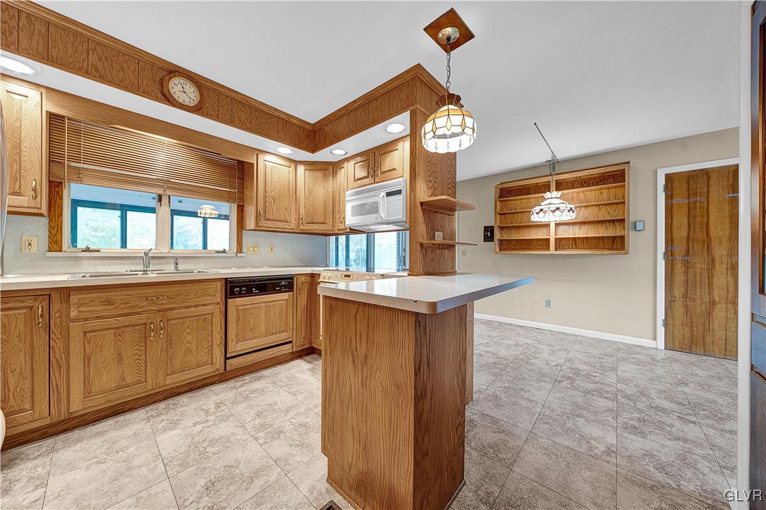 5651 Park Valley Road Schnecksville, PA 18078 - Photo 7 of 32 a kitchen with stainless steel appliances granite countertop a stove a sink and a microwave