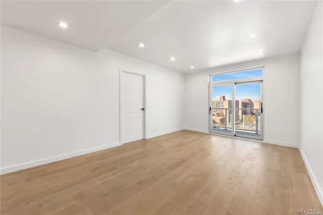 a view of a room with wooden floor and a window