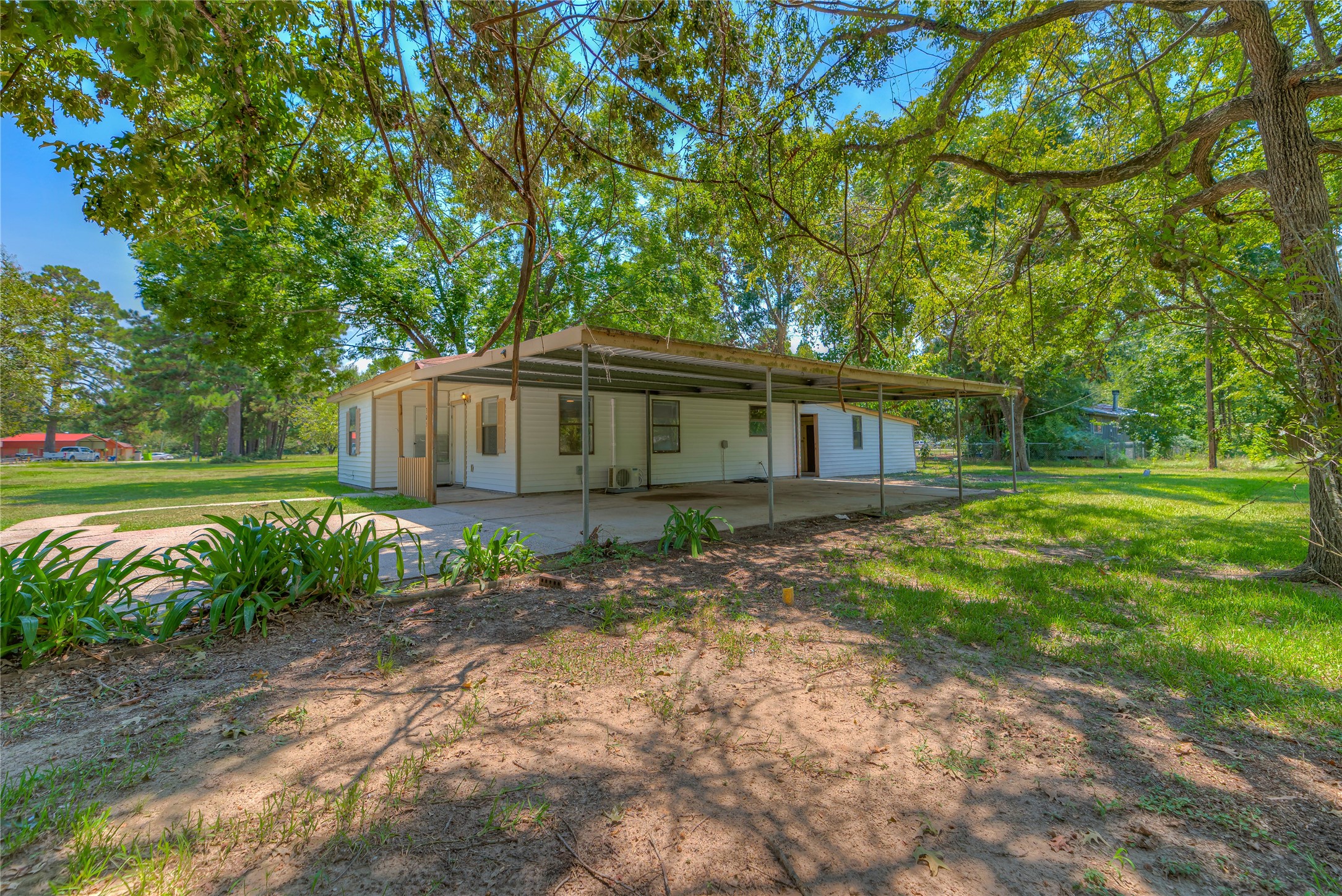 305 Oak Ridge Drive Onalaska, TX 77360 - Photo 18 of 29 a view of a house with a yard