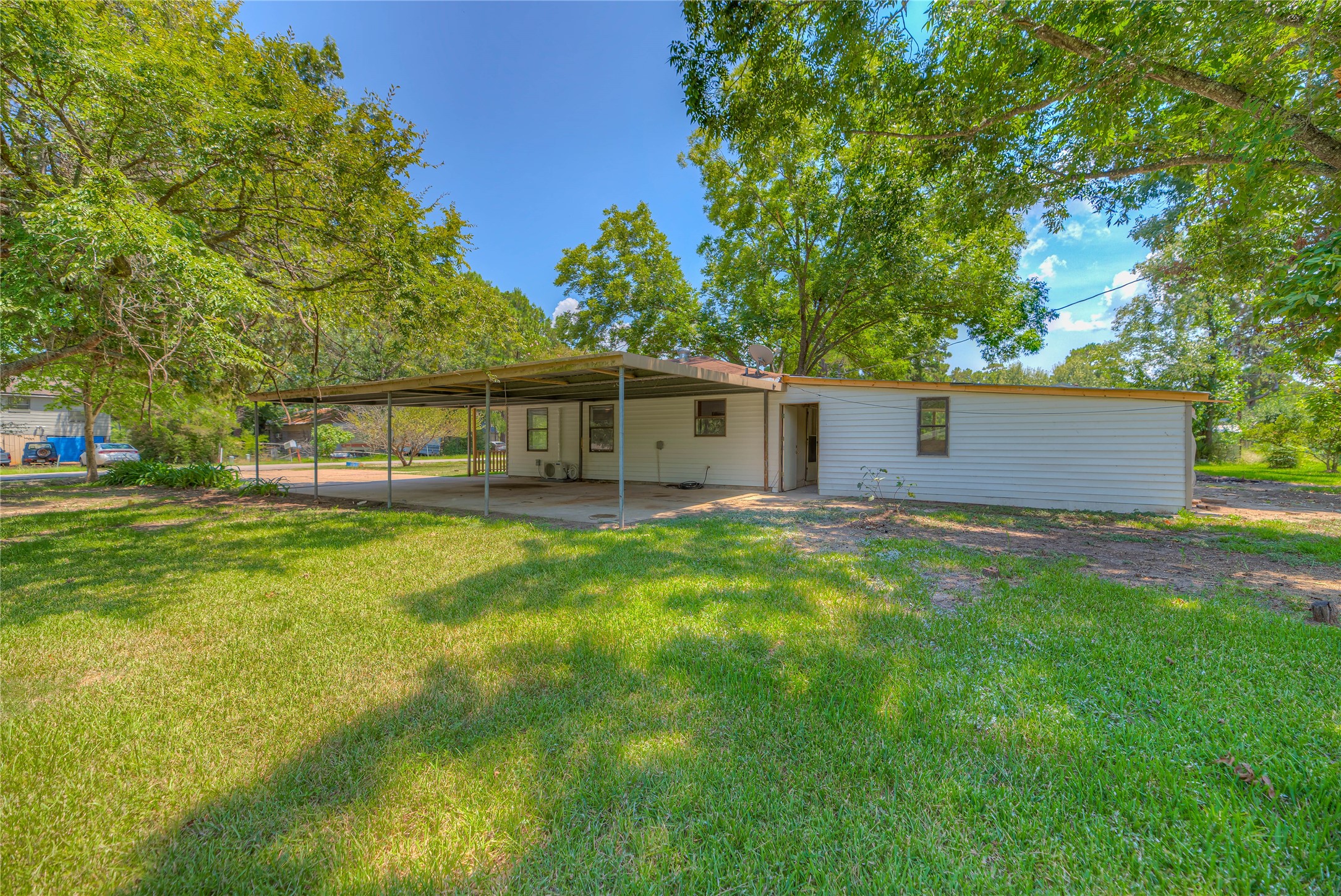 305 Oak Ridge Drive Onalaska, TX 77360 - Photo 19 of 29 a view of a house with a backyard