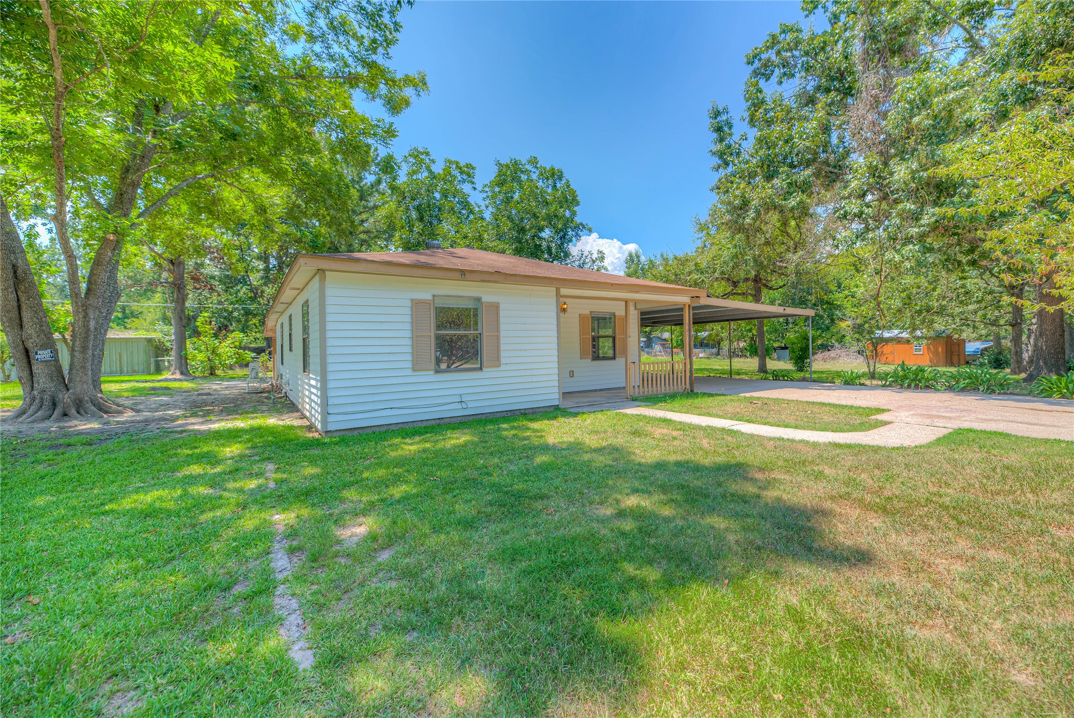 305 Oak Ridge Drive Onalaska, TX 77360 - Photo 24 of 29 a view of a house with a backyard