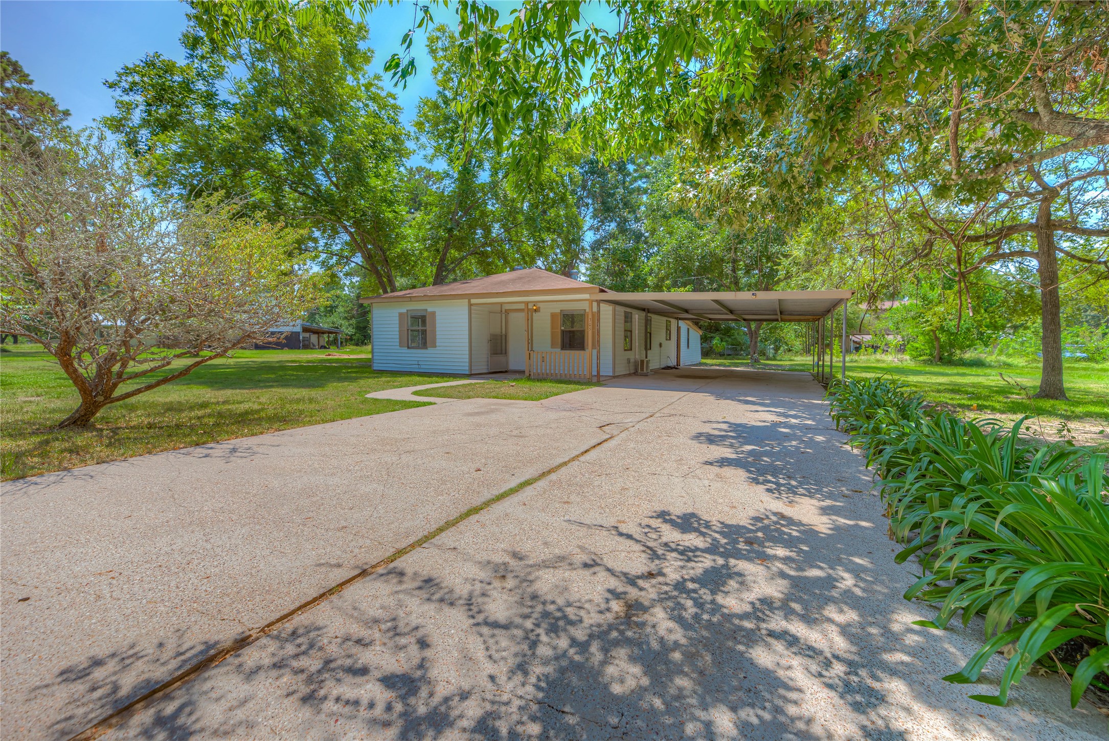 305 Oak Ridge Drive Onalaska, TX 77360 - Photo 25 of 29 a view of a house with a yard