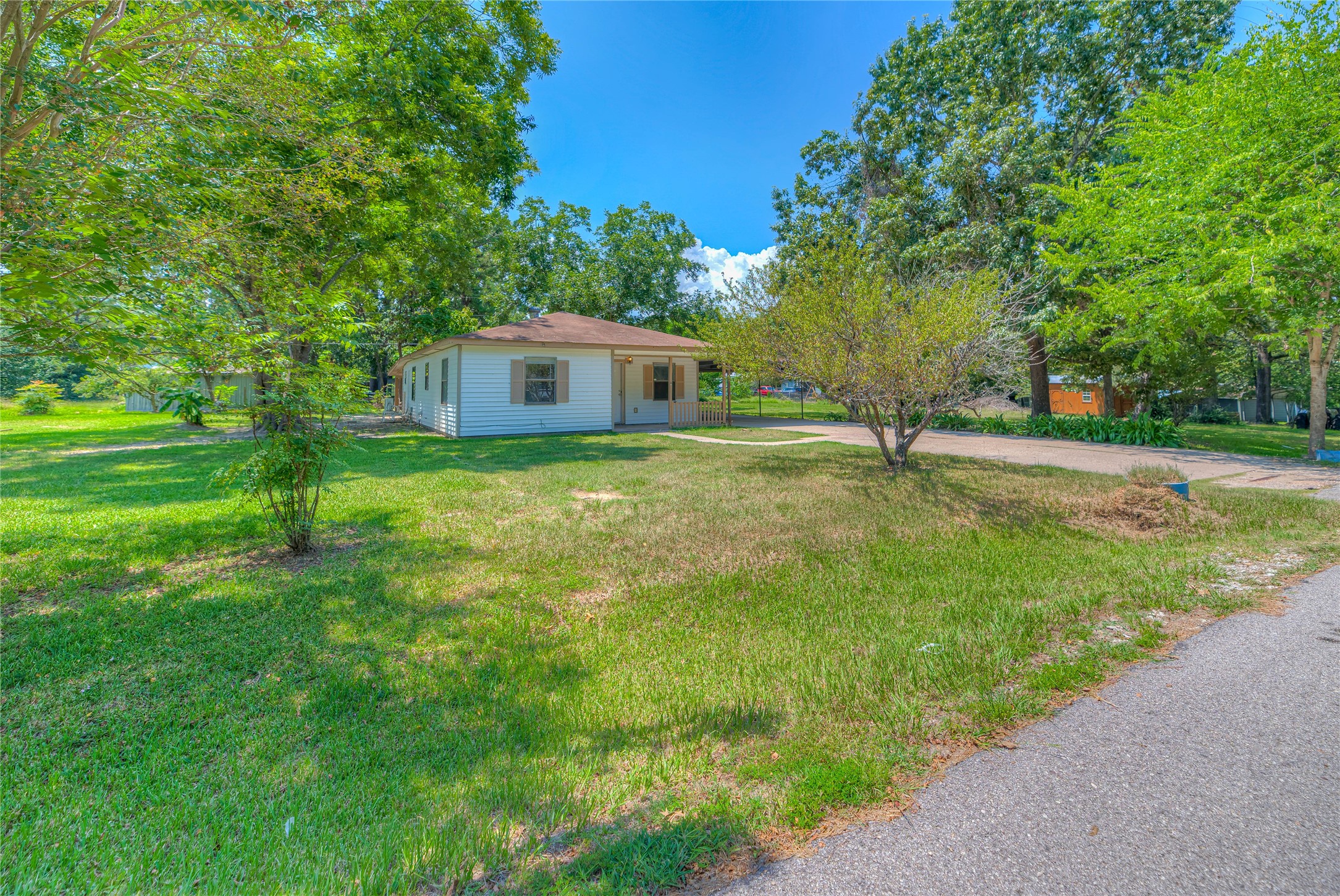 305 Oak Ridge Drive Onalaska, TX 77360 - Photo 26 of 29 a house with a tree in front of it