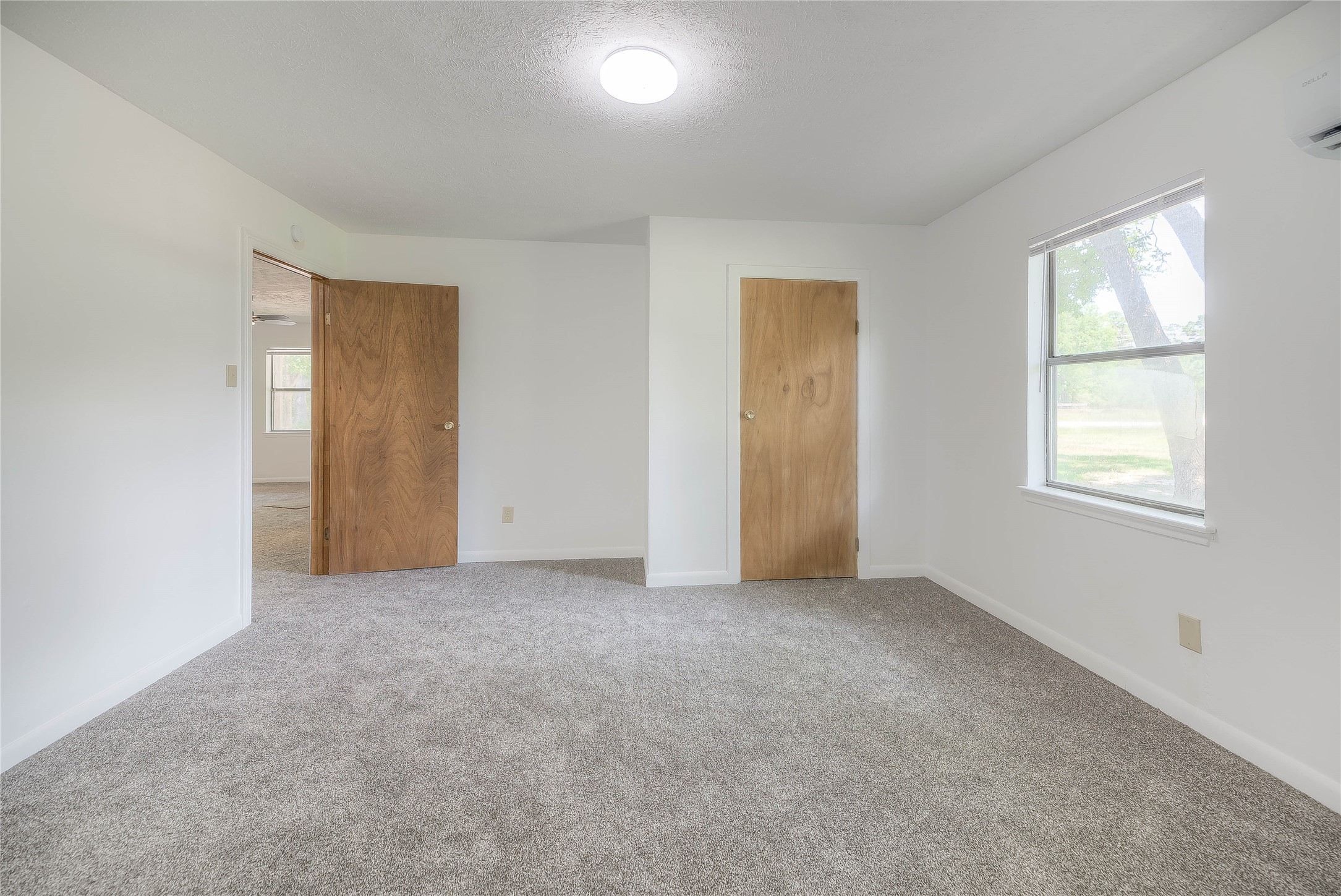 305 Oak Ridge Drive Onalaska, TX 77360 - Photo 7 of 29 an empty room with windows and closet