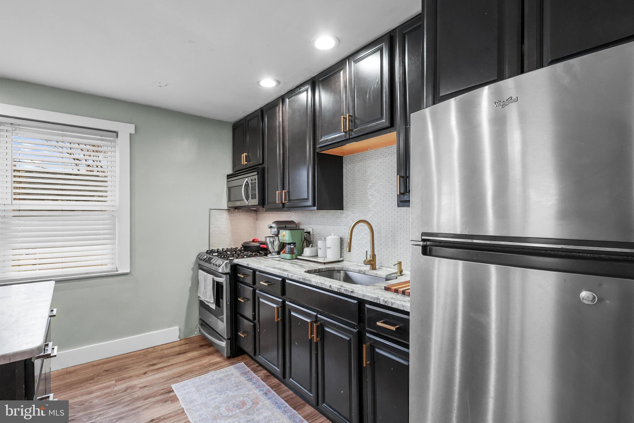 1020 Dartmouth Road Baltimore, MD 21212 - Photo 13 of 46 a kitchen with stainless steel appliances a refrigerator sink and cabinets
