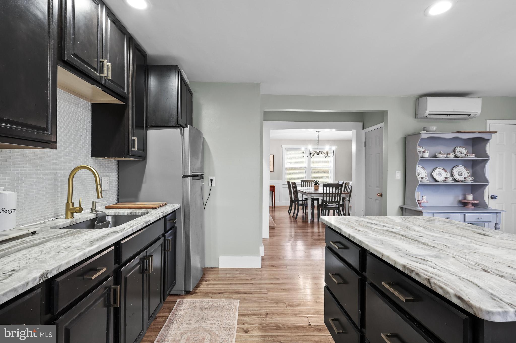 1020 Dartmouth Road Baltimore, MD 21212 - Photo 16 of 46 a kitchen with granite countertop a sink stove and refrigerator