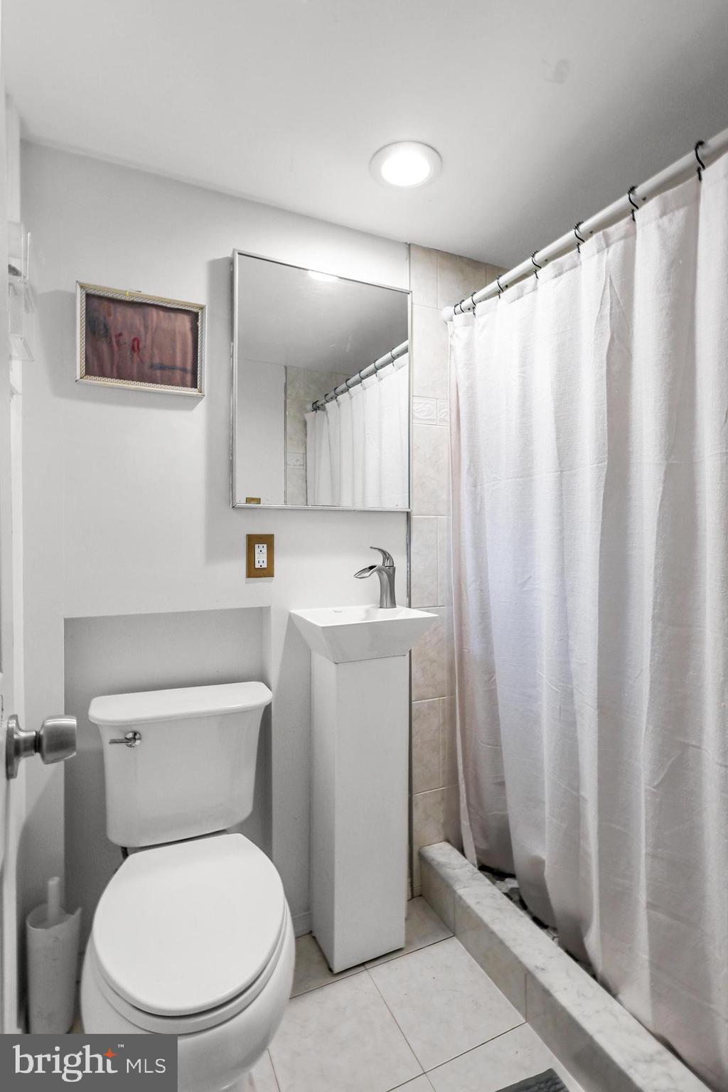 1020 Dartmouth Road Baltimore, MD 21212 - Photo 36 of 46 a white toilet sitting next to a bathroom sink