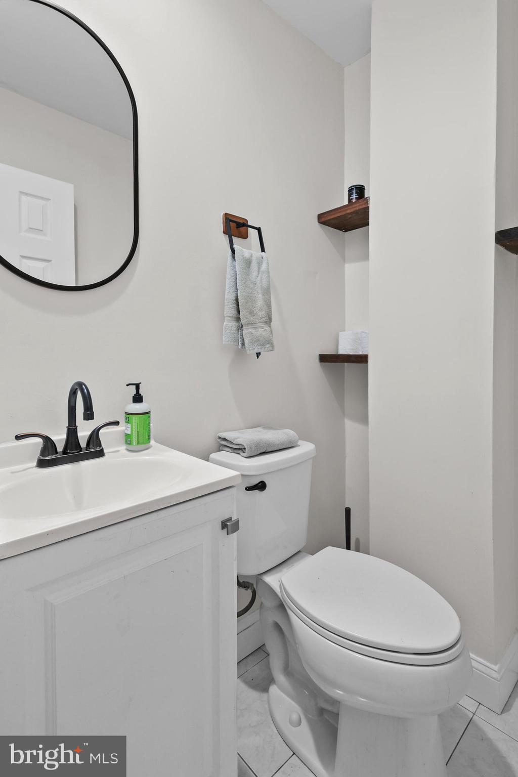 1020 Dartmouth Road Baltimore, MD 21212 - Photo 10 of 46 a bathroom with a sink a toilet and mirror